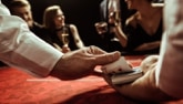Dealer with cards at table